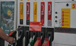 A person holds a fuel dispenser at the pay-at-the-pump gasoline pump in Krakow.On Thursda...