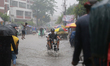 A man rides motorbike during the rainfall in Dhaka, Bangladesh on May 30, 2022.  