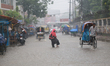 A woman walks on the street during the rainfall in Dhaka, Bangladesh on May 30, 2022.  