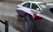 A Palestinian schoolgirl hold an umbrella as they go to school on a rainy day in  Gaza Cit...