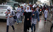 Palestinian schoolgirls  go to school on a rainy day in  Gaza City October 7, 2015.  