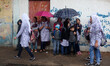 Palestinian schoolgirls hold an umbrella as they go to school on a rainy day in  Gaza City...