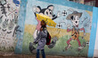 A Palestinian schoolgirl hold an umbrella as they go to school on a rainy day in  Gaza Cit...