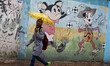 A Palestinian schoolgirl hold an umbrella as they go to school on a rainy day in  Gaza Cit...