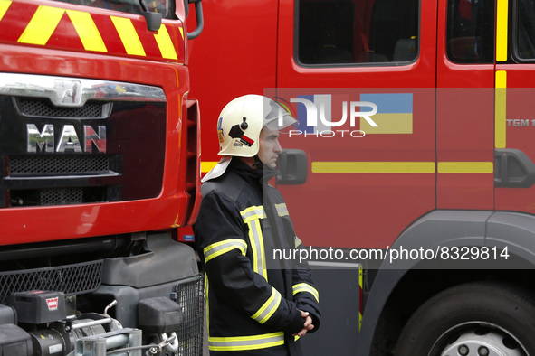 KYIV, UKRAINE - MAY 30, 2022 - A rescuer is pictured next to the firefighting and other special vehicles handed over for the needs of the SE...
