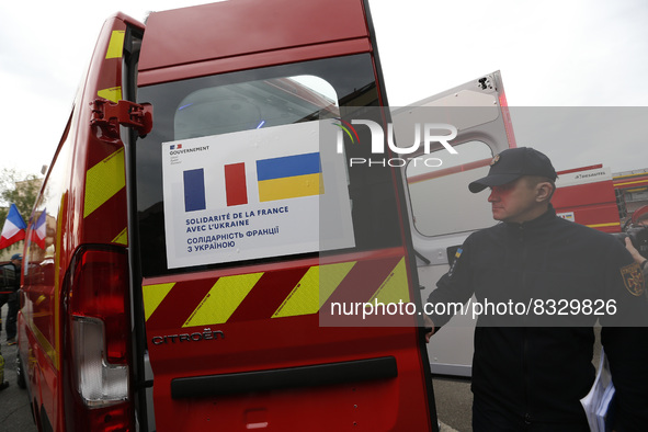 KYIV, UKRAINE - MAY 30, 2022 - A rescuer is pictured next to the firefighting and other special vehicles handed over for the needs of the SE...