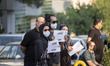Iranian people hold placards with Persian scripts read, Condolences my Iran, as they atten...