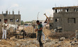 A Palestinian construction worker removing house rubble bombed during the 2014 Gaza war at...