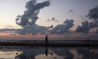 A Palestinian man walks past a pool of rain water during the sunset at the beach of Gaza c...