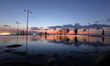 Palestinians stand in front a pool of rain water during the sunset at the beach of Gaza ci...