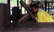 QUEZON CITY, Philippines - A staff of the chapel arranges wooden crosses to be carried by...