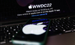 Apple website displayed on a laptop screen and Apple logo displayed on a phone screen are...