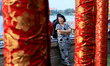 Members of the Chinese community watch on a lion dance during a Dragon Boat Festival celeb...