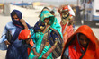 Local commuters pass through massive heatwave during a hot day at sangam in Allahabad on J...