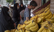 Iranian women shop at a fruit shop at the Shapour Bazaar (Market) in southern Tehran on Ju...