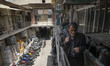 An Iranian man walks past shoe workshops in the Shapour Bazaar (Market) in southern Tehran...