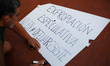 An activist from  the Victims' Mortgage Platform (PAH) writes a slogan in a poster while c...