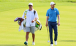 Daniel Berger of Jupiter, Florida walks with his caddie to the 17th green during the final...