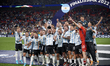 Lionel Messi (Paris Saint-Germain) of Argentina lifts the trophy after winning with his te...