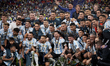 Lionel Messi (Paris Saint-Germain) of Argentina lifts the trophy after winning with his te...