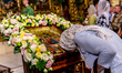A woman pray by an icon during a Holy Mass on Holy Trinity Holiday, also called Green Holi...