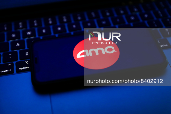 AMC logo displayed on a phone screen and a laptop keyboard are seen in this illustration photo taken in Krakow, Poland on June 14, 2022. (Ph...