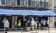 People queue in front of the historical shop Pasteleria de Belem in Lissabon, Portugal on...