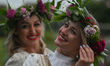 Two young women in a flower wreaths during the Kupala Night celebrations, the Slavic summe...