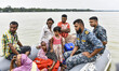 Bangladesh Navy rescue a family from a flooded area following heavy monsoon rainfalls in S...