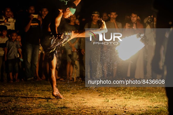 Villagers playing fire football, known locally as "sepak bola api", a fireball made from a coconut from a palm tree soaked during an annual...