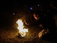 Villagers leaders prepare a ritual prior to playing fire football, known locally as "sepak bola api", a fireball made from a coconut from a...