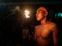 Villagers carry torches as they participate in playing fire football, known locally as "sepak bola api", a fireball made from a coconut from...