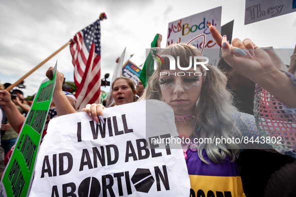 A clinic escort gives anti-abortion protesters the finger prior to the Supreme Court's announcement of its opinion on Dobbs v. JWHO.  The op...