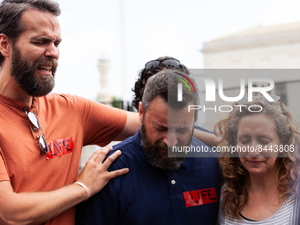 Members of Bound 4 People, a Christian group, break down while praying after the Supreme Court issued its opinion on Dobbs v. JWHO.  The opi...