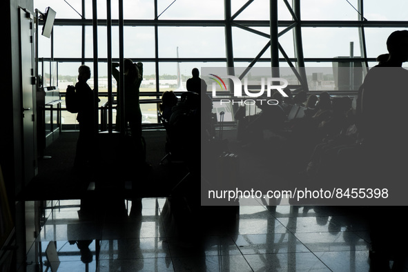 Morning departing and arriving passengers are seen carrying their luggage inside the terminal and the gates area of Brussels Zaventem Airpor...