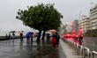 People spent time in Marine Drive during heavy rainfall in Mumbai, India, 04 July, 2022.  