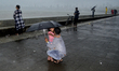A man kiss her child as they enjoy heavy rainfall in Mumbai, India, 04 July, 2022.  