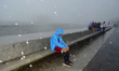 An old man enjoys heavy rainfall in Marine drive, Mumbai, India, 04 July, 2022.  