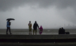 People spent time in Marine Drive during heavy rainfall in Mumbai, India, 04 July, 2022.  