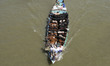 A vessel carrying cattle for sale heads to a market before Eid al-Adha in Dhaka, Banglades...