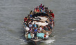 A vessel carrying cattle for sale heads to a market before Eid al-Adha in Dhaka, Banglades...