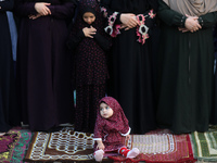 Palestinian women and children perform the al-Adha feast prayers in Gaza City, on the first day of the feast celebrated by Muslims worldwide...