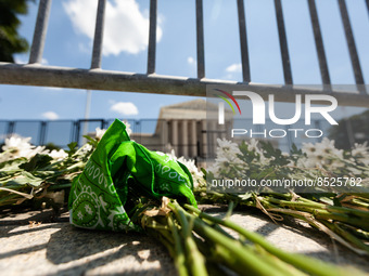 Flowers and a green bandana (an international symbol for reproductive rights) lie at the foot of the Supreme Court, after members of NextGen...