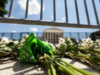 Flowers and a green bandana (an international symbol for reproductive rights) lie at the foot of the Supreme Court, after members of NextGen...