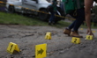 Experts take evidence during an operative after the shooting due to a confrontation betwee...