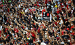 Fans are seen at the stand during the Liverpool FC open training session ahead of the Stan...