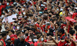 Fans cheer as the Liverpool FC players walk back to the tunnel after the open training ses...