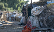 A Palestinian Bedouin woman sits outside her tent in Gaza City on July 17, 2022. 