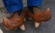 Detail of some albarcas (typical regional footwear) of a visitor to the cattle exhibition...
