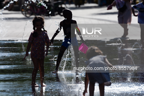 Kids play with the water of a fountain in city center of  Duesseldorf, Germany on July 18, 2022 as a heat wave reaches to Germany 